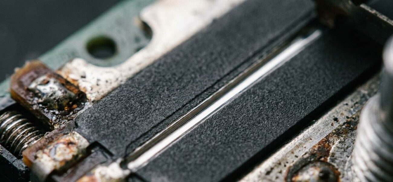 Analog stick repair showing a worn groove in the resistive track under magnification